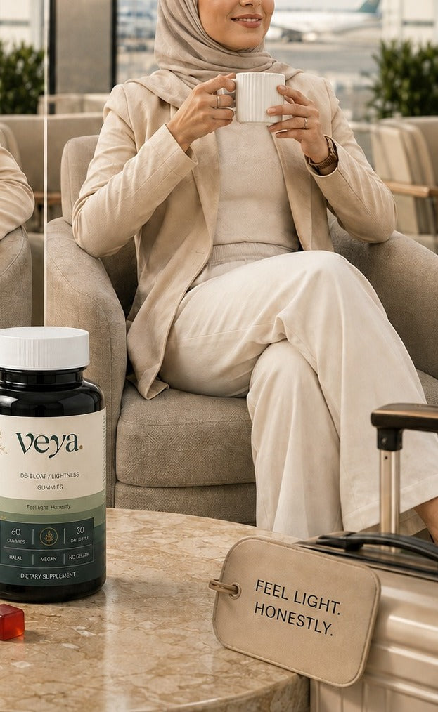A woman with a cup in an airport lounge, the Veya jar beside her.