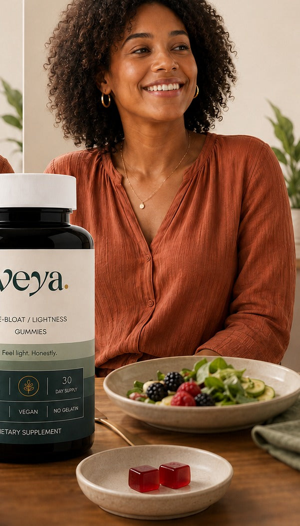 A woman at a lunch table with a salad bowl and the Veya jar.
