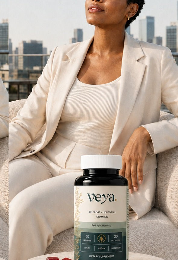 A woman in a cream suit on a rooftop terrace, the Veya jar beside her.