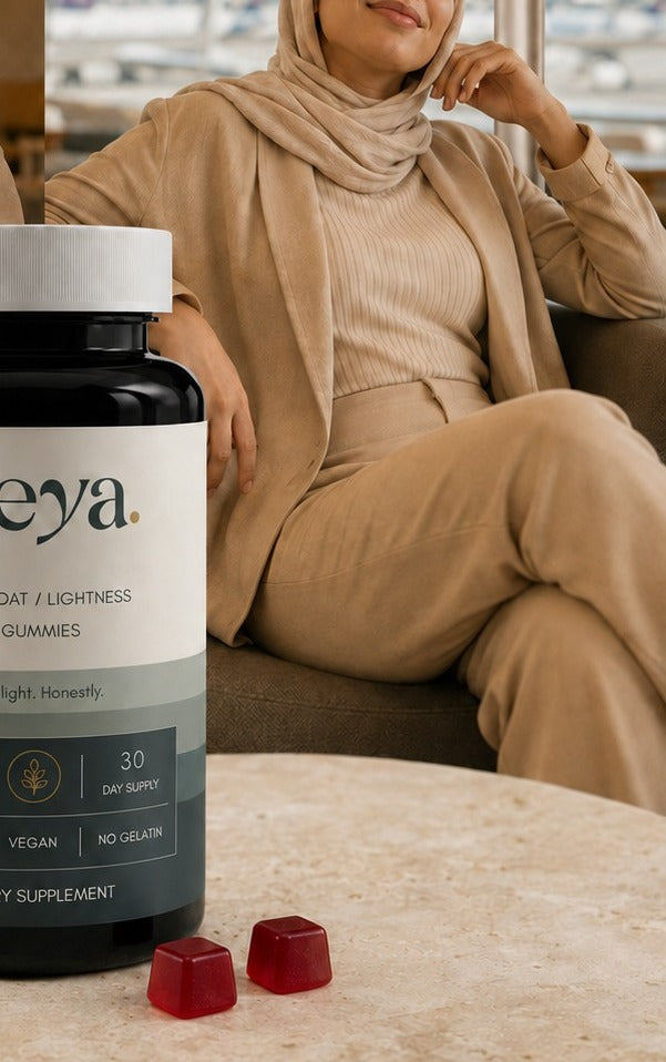 A woman resting in an airport lounge chair, the Veya jar on the table.