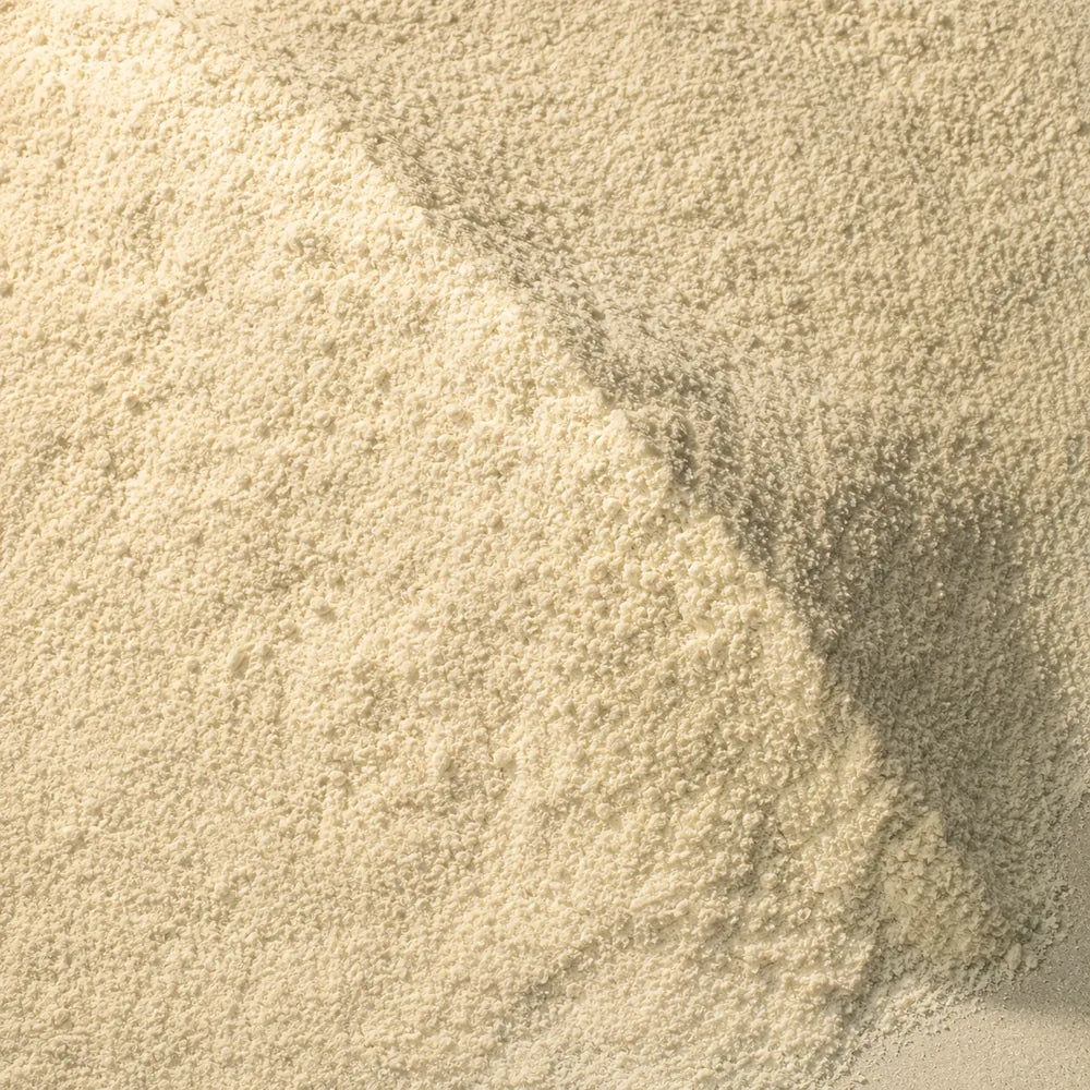 Fine milled powder drifted across pale limestone