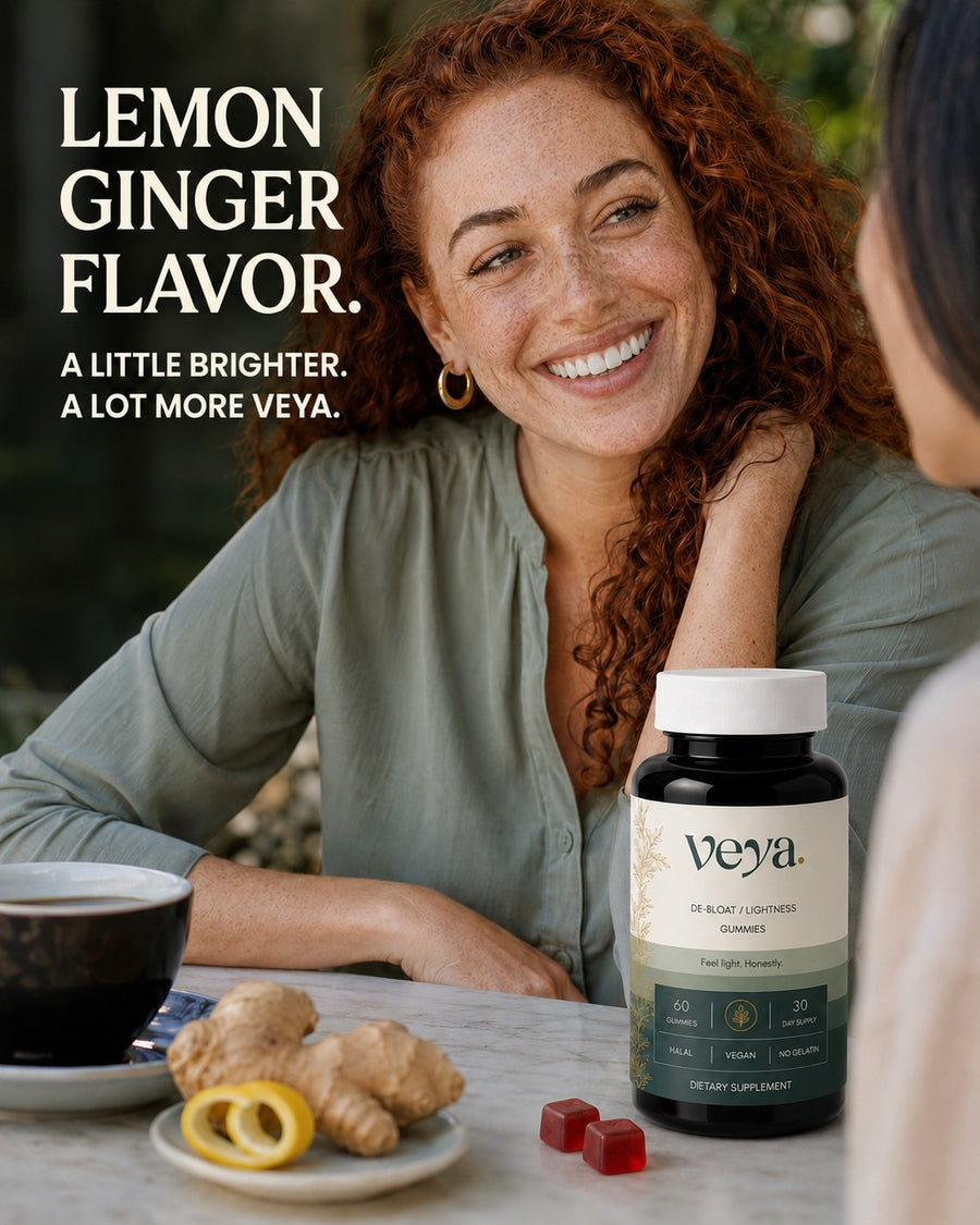 A woman at a cafe table with ginger and lemon beside the jar.