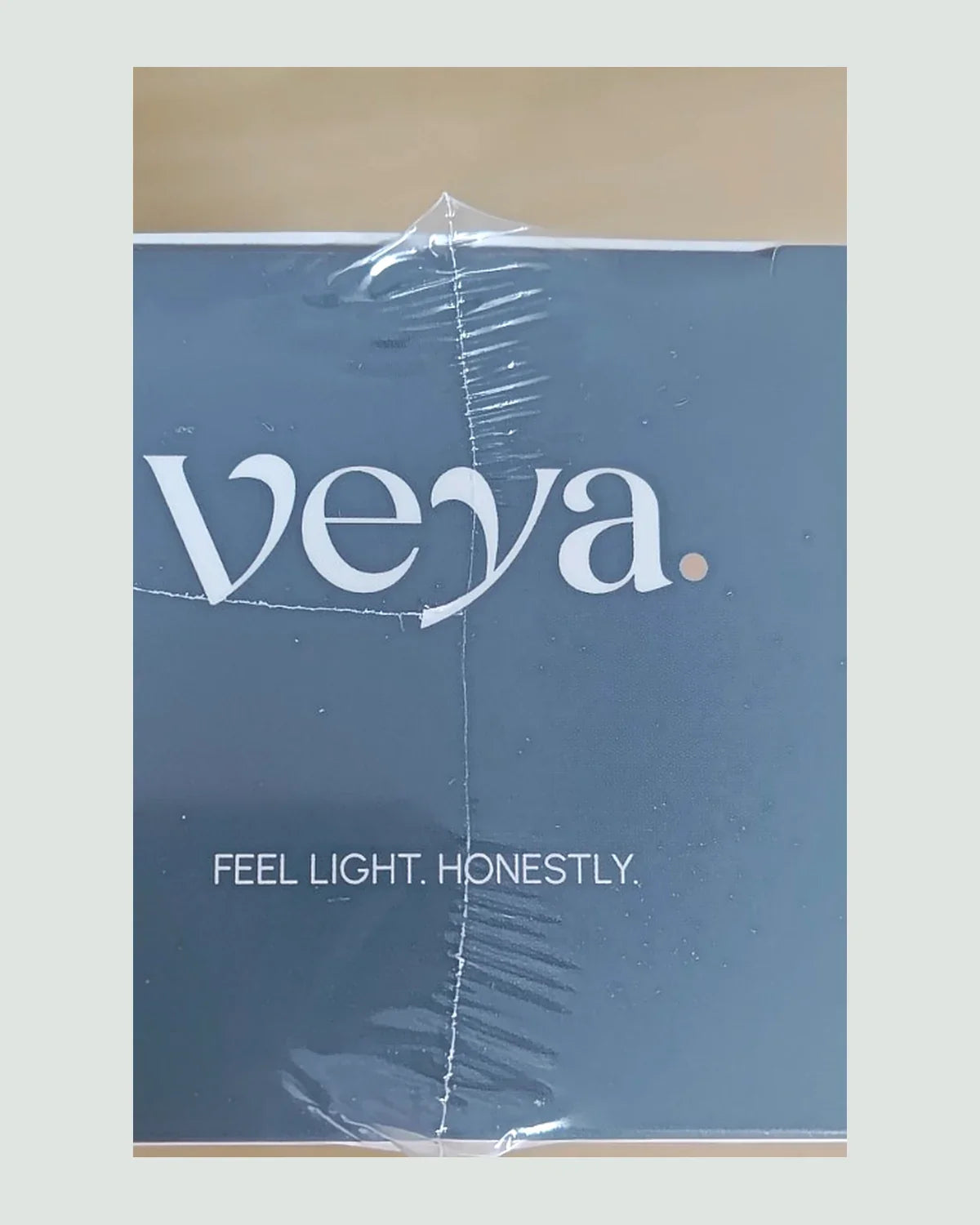 The Veya carton in slate blue, wordmark and the line feel light honestly.