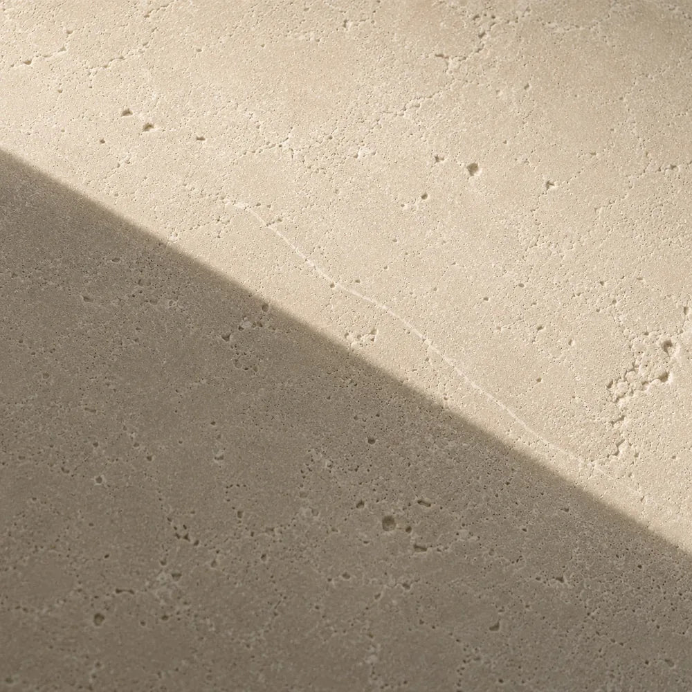 Bare limestone crossed by one hard diagonal shadow